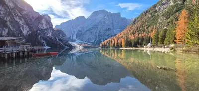 a river between two mountains with a boat in the water at WEINBERG APARTMENTS with Brixen Südtirol Card in Naz-Sciaves