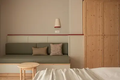a bed and a table in a room at Vitalpina Hotel Schulerhof in Plaus