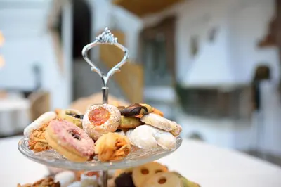 a glass plate filled with different types of pastries at Garni Hotel and Apartments Wildbach in Selva di Val Gardena