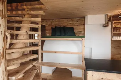 a room with a bunk bed in a log cabin at Hirschhof Pfrein - Hideaway in Chiusa