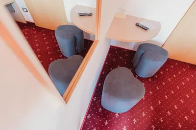 a reflection of two chairs and a table in a mirror at Pension Wiesenrain in Maranza
