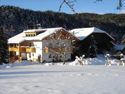 a house covered in snow in the snow at Haus Bergfrieden in Castelrotto