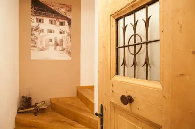 a door in a room with a window and stairs at Agriturismo Sittnerhof in Merano
