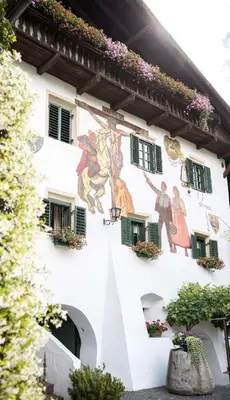a building with paintings on the side of it at Agriturismo Sittnerhof in Merano