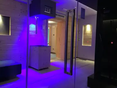 a room with purple lights in a room at Hotel El Paster in Pozza di Fassa