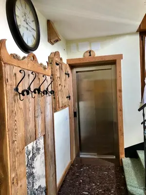 a garage door with a clock on the wall at Stella Alpina in Voltago