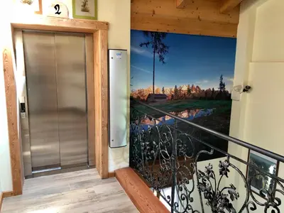 a door to a balcony with a painting on the wall at Stella Alpina in Voltago