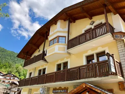a building with a balcony on the side of it at Stella Alpina in Voltago