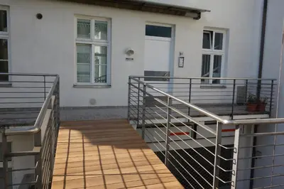 a balcony of a house with a wooden floor at Hager Apartment 2 in Merano