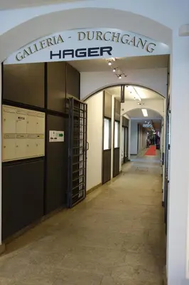a hallway in a building with a sign that reads calima duinginteger at Hager Apartment 2 in Merano