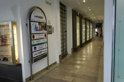 a hallway of a store with a sign on the wall at Hager Apartment 2 in Merano