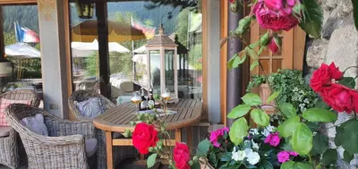 a bunch of flowers in front of a mountain at Villa Martha Vintage Hotel-B&B in Santa Cristina in Val Gardena