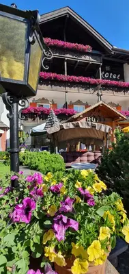 a street light with flowers in front of a building at Villa Martha Vintage Hotel-B&B in Santa Cristina in Val Gardena
