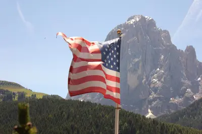an american flag flying in front of a mountain at Villa Martha Vintage Hotel-B&B in Santa Cristina in Val Gardena
