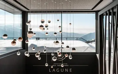 a house with a swimming pool in the snow at Parkhotel Holzerhof in Maranza