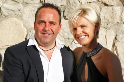 a man and a woman posing for a picture at Hotel Valpudra in Selva di Val Gardena