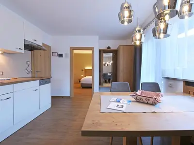 a kitchen and dining room with a table and chairs at Residence Hotel Fever in Ortisei