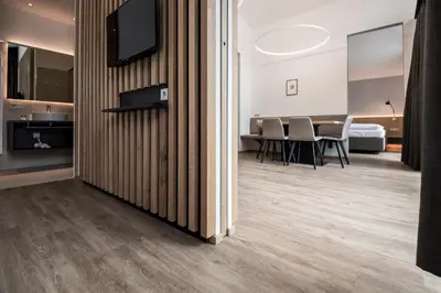 a living room with a table and chairs at Residence Hotel Fever in Ortisei