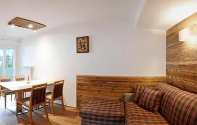 a living room with a couch and a table at Residence Hotel Fever in Ortisei