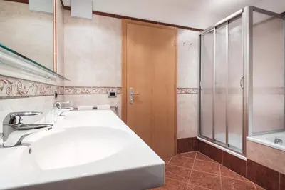 a bathroom with a sink and a shower at BergHotel Majarei in San Vigilio Di Marebbe