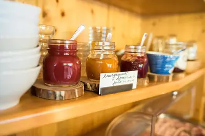 a wooden shelf with jars of honey on it at Garni Ortles in Selva di Val Gardena