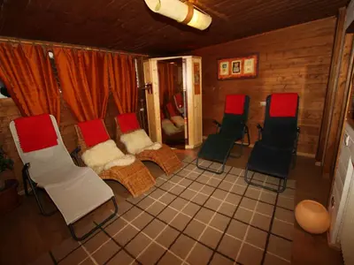a group of chairs sitting in a room at Garni Ortles in Selva di Val Gardena