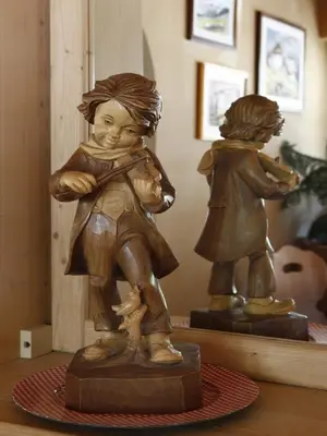 a statue of two children standing next to each other at Garni Ortles in Selva di Val Gardena