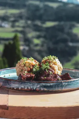 a plate of food with broccoli and meat on a table at Hotel Residence Gasser in Villandro