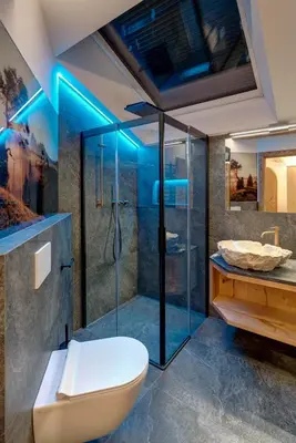 a bathroom with a shower and a toilet and a sink at Hotel Residence Gasser in Villandro