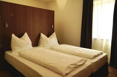 a bedroom with a bed with white sheets and pillows at Residence Larciunei in Ortisei