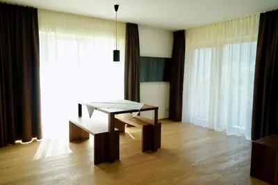 a dining room with a table and a chair at Residence Larciunei in Ortisei