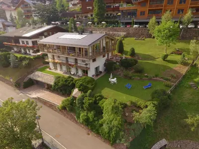 an aerial view of a large house with a yard at Residence Larciunei in Ortisei