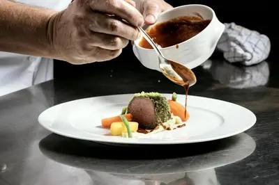 a person holding a cup of tea with a plate of food at Piccolo - Dolomites & Gourmet Hotel in Selva di Val Gardena