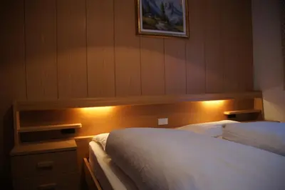 a bedroom with a bed with lights on it at Ciasa Complojer in La Valle