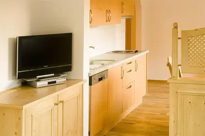 a kitchen with a flat screen tv on a counter at Residence Rumanon in Ortisei