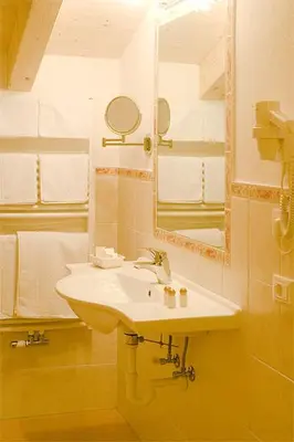 a bathroom with a sink and a mirror at Residence Rumanon in Ortisei