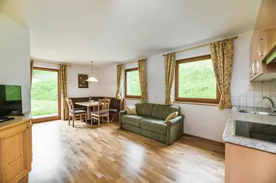 a living room with a couch and a table at Residence Rumanon in Ortisei