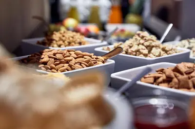 a table topped with bowls of nuts and other foods at Hotel Walther v.d. Vogelweide Superior in Chiusa