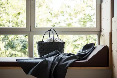 a blanket sitting on a window sill with a basket at Hotel Alpenflora in Castelrotto