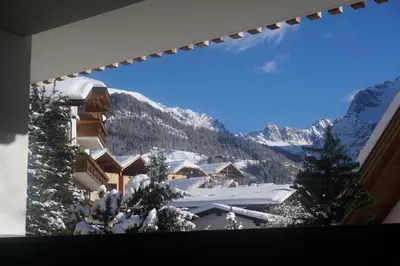 a view of a snow covered mountain from a ski lodge at La Palsa in La Valle