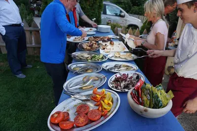 a long blue table with plates of food on it at La Palsa in La Valle