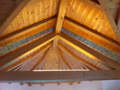 a roof of a wooden building with wooden beams at Garni la Bercia in Selva di Val Gardena