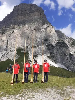 a group of men standing in front of a mountain at Garni la Bercia in Selva di Val Gardena