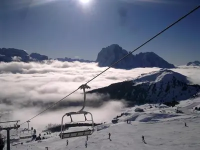 a ski lift on top of a snow covered mountain at Garni la Bercia in Selva di Val Gardena