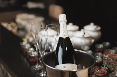 a bottle of wine in a bucket on a table at Das Mondschein in Obereggen
