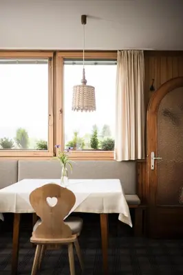a dining room with a table and a window at Pension Haus Tirol in Laion