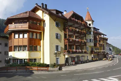 a building on the side of a street at Hotel Corona Krone in Selva di Val Gardena