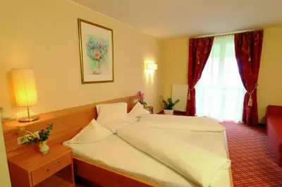 a hotel room with a bed and a window at Hotel Stamserhof in Andrian