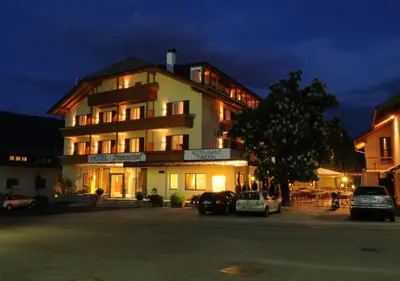 a large building with cars parked in front of it at Hotel Stamserhof in Andrian
