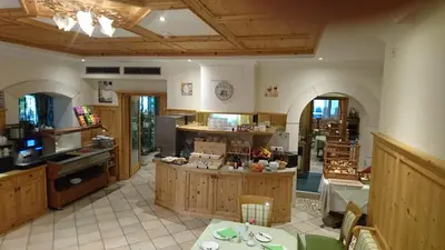 a large kitchen with an island in the middle at Hotel Stamserhof in Andrian